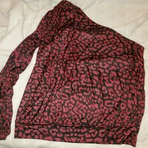 Woman's off shoulder top. Left arm has slit.